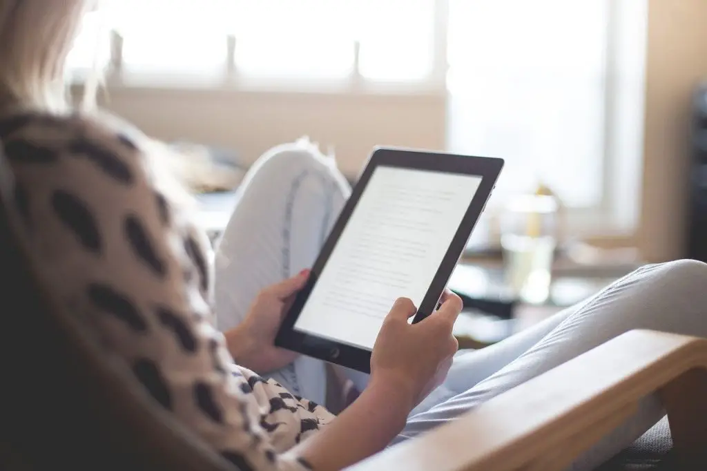 picture of women reading on her amazon kindle